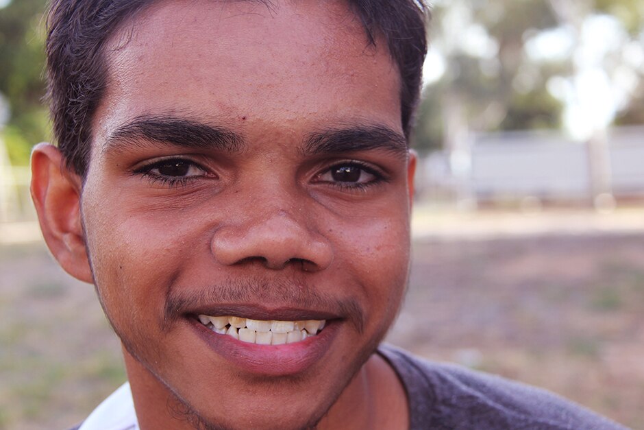 An Aboriginal boy looks directly at the camera
