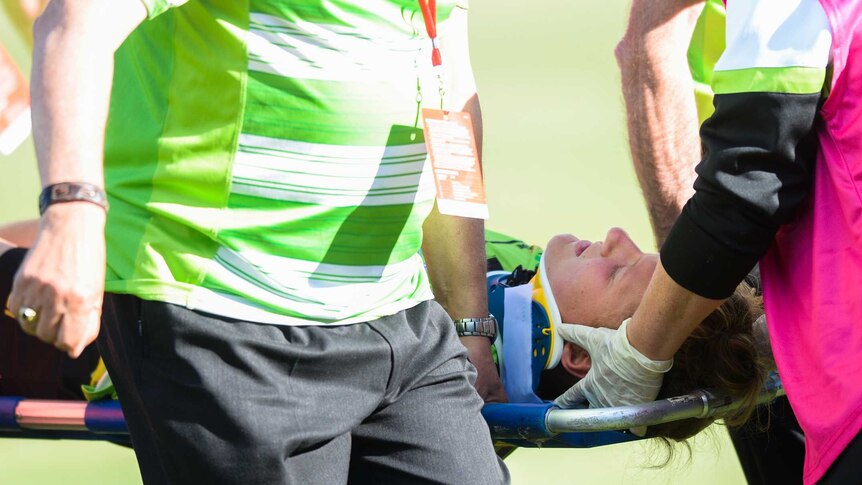 A soccer player is taken from the field after getting injured