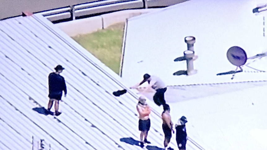 Detainees climb onto Malmsbury correction facility roof.