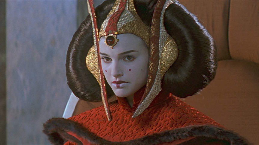 Natalie Portman with her face painted and an elaborate headdress