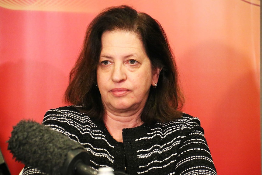 picture of Audrey ZIbelman at a microphone