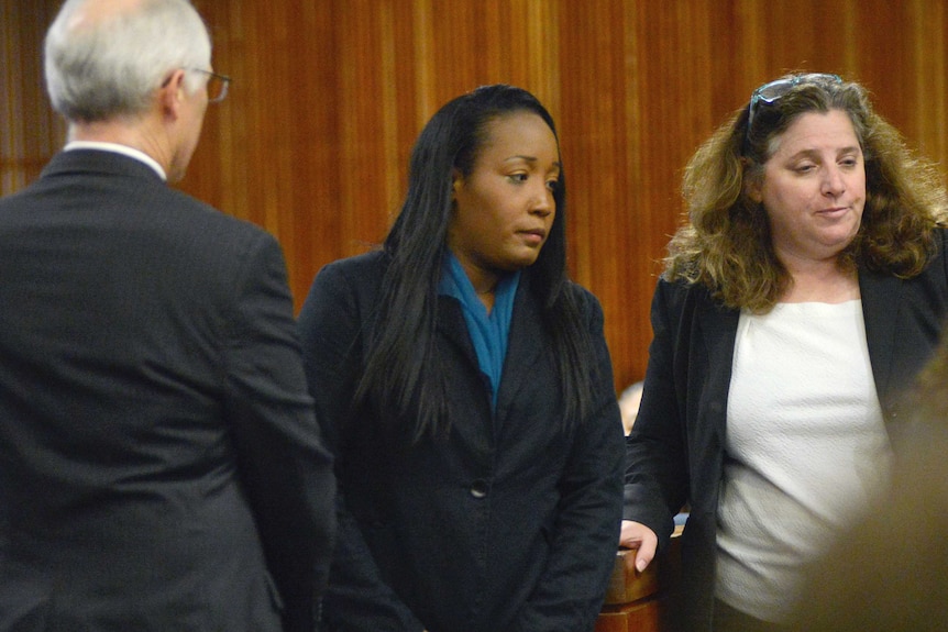 Ina Rogers is photographed in court standing next to two unnamed people