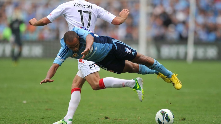 Sydney FC's Fabio (R) is brought down by Jason Hoffman of the Melbourne Heart.