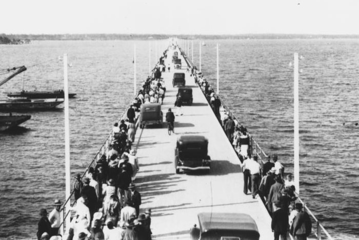 A crowd of people make their way across the new Hornibrook Highway viaduct on the day of it's official opening in 1935