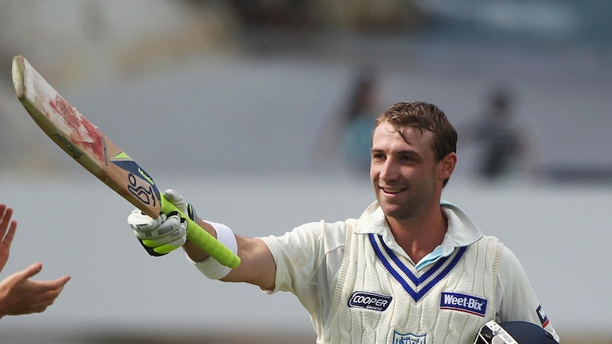 Phillip Hughes celebrates his century during the Sheffield Shield final match in 2011.