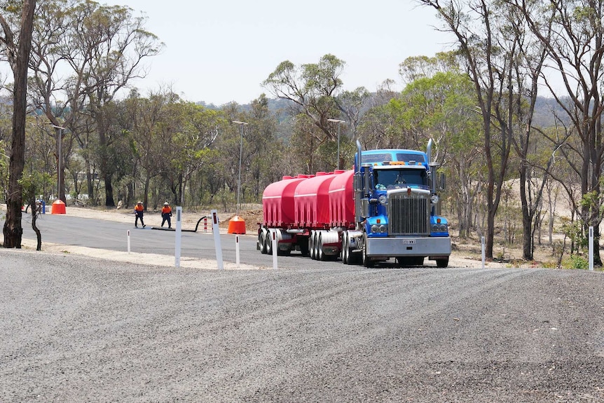 A truck drives away after delivering water to Storm King Dam in Stanthorpe.