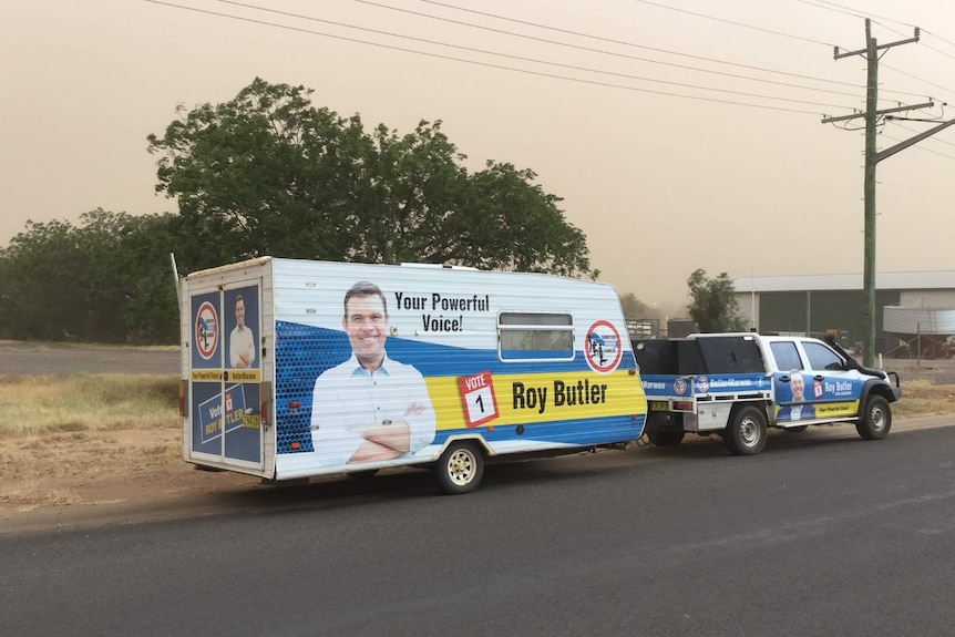 Roy Butler's ute and van parked on the side of a road against the back drop of a dust storm