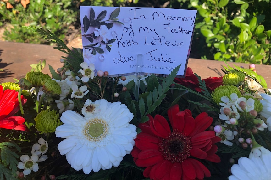 A wreath with a card remembering Keith Lefeve