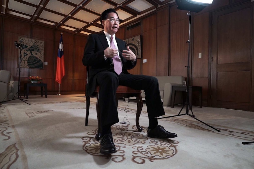 Taiwan's foreign minister Joseph Wu sits on a chair during an interview