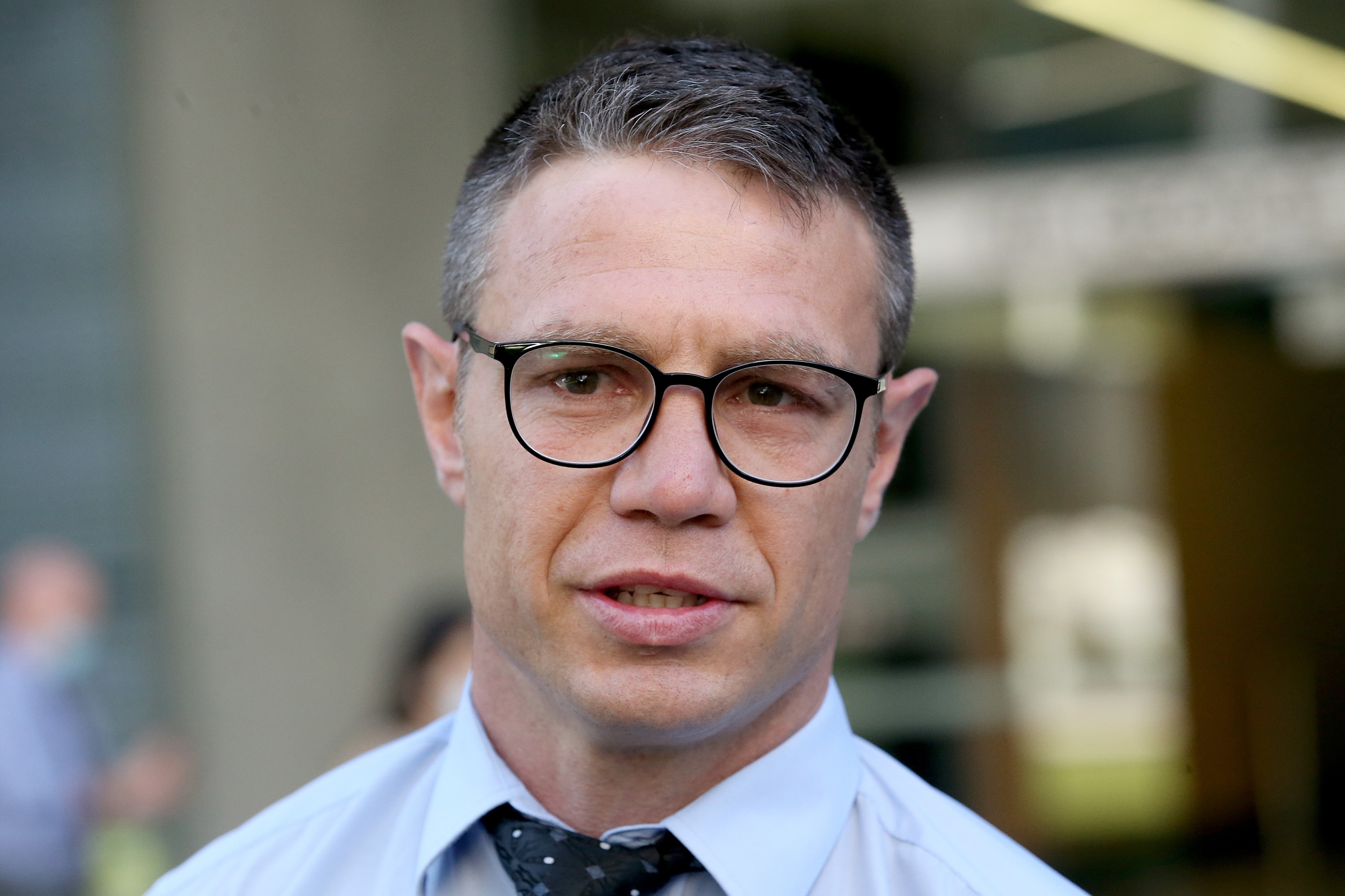 man standing outside building