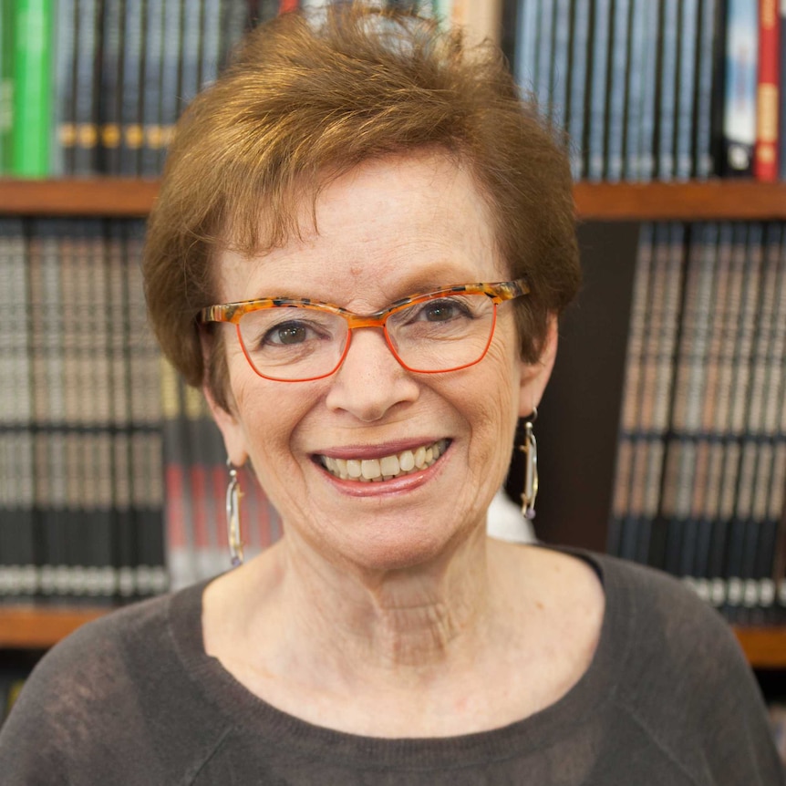 Economist Dr Eileen Appelbaum smiles while sitting in front of a bookshelf.