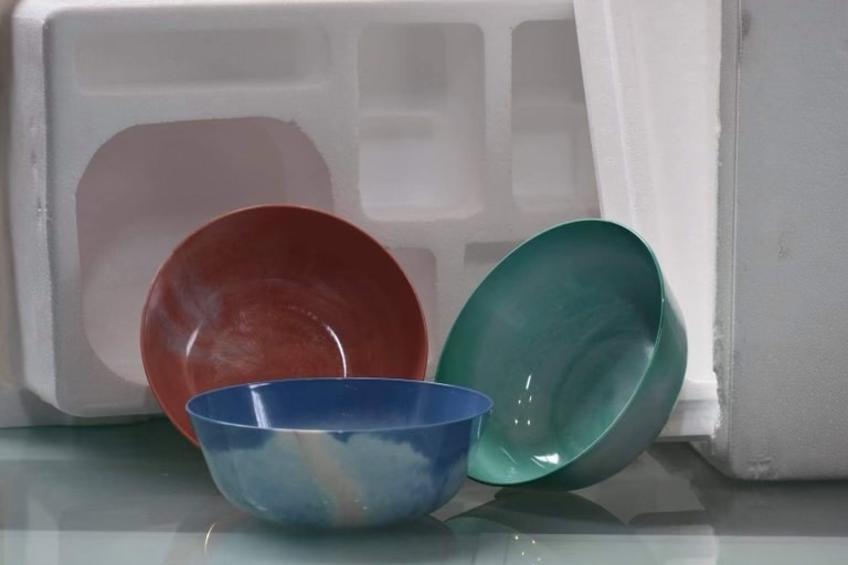 Three coloured bowls sit in front of white polystyrene.