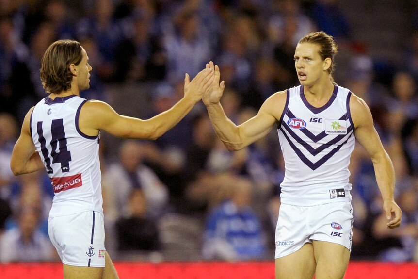 Nat Fyfe gives Dockers teammate Lachie Weller a high five.