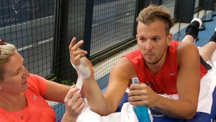 Dylan Alcott get treatment during tennis challenge