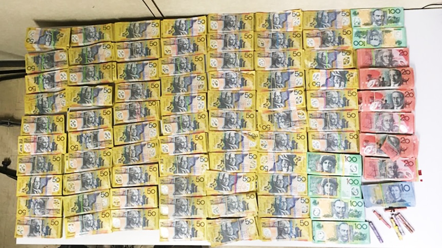 Police seized more than $400,000 in cash in raids on two Gold Coast properties.