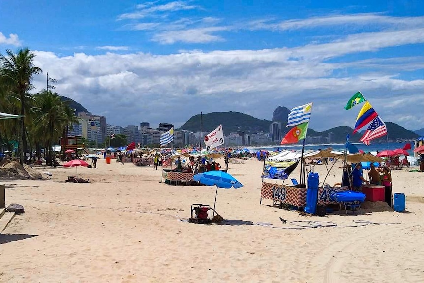 people and flags on a beach in Rio De Janeiro