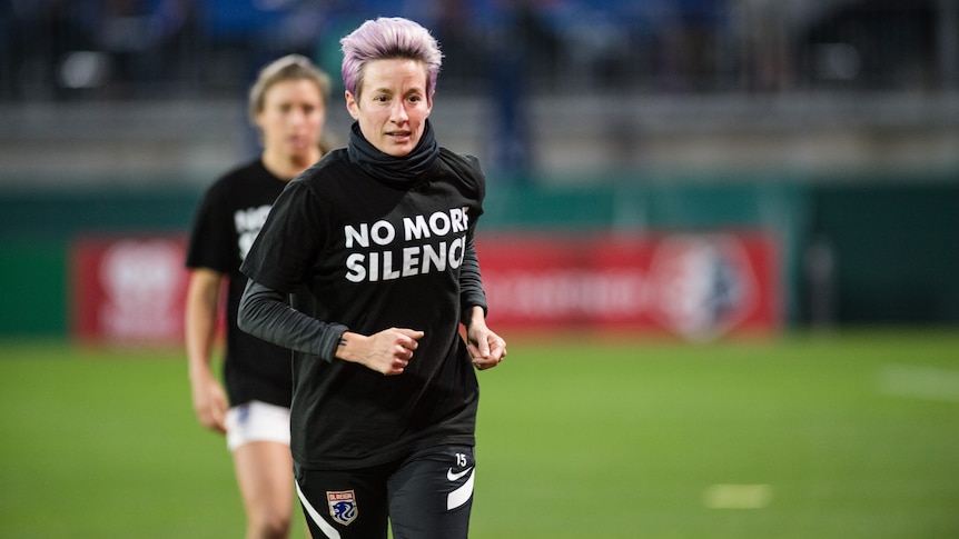 Soccer players warm up before a match wearing shirts sending a powerful message