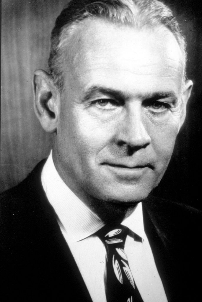Black and white portrait of a middle-aged man who has light eyes and black hair.