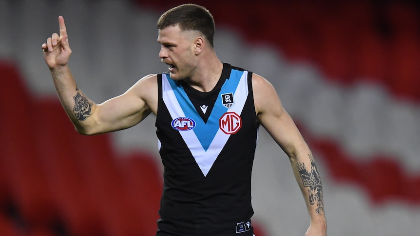 A Port Adelaide AFL player points his finger during the 2021 season.