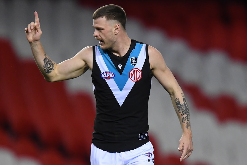 A Port Adelaide AFL player points his finger during the 2021 season.