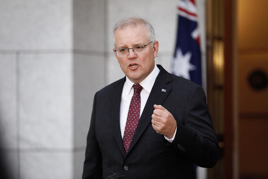 Scott Morrison talks to a camera in a marble courtyard