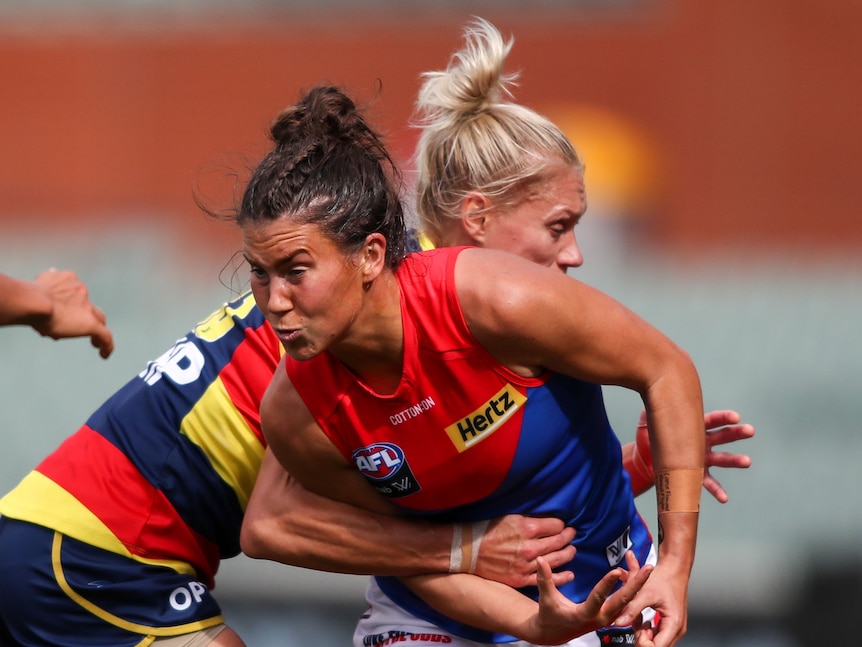 Two AFLW players collide in a contest for the ball.