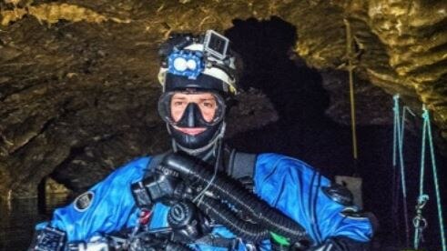 Stephen Fordyce in caving gear in water.