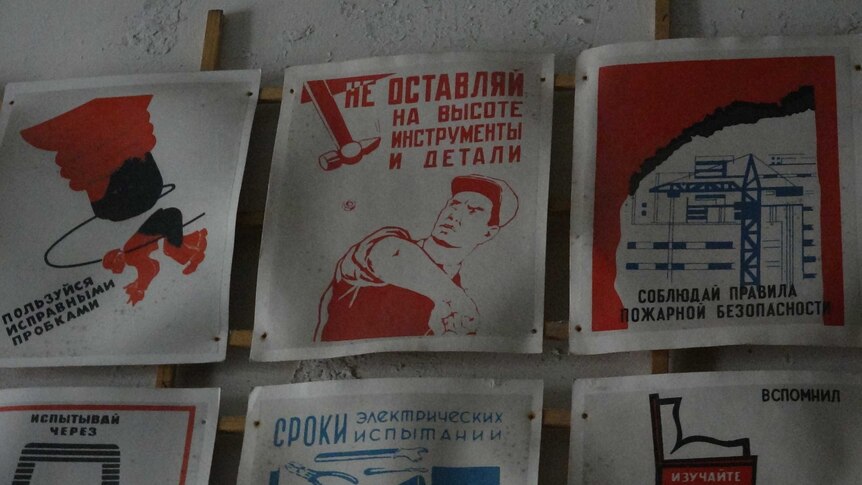 Old Soviet posters remain within the abandoned buildings at Pyramiden.