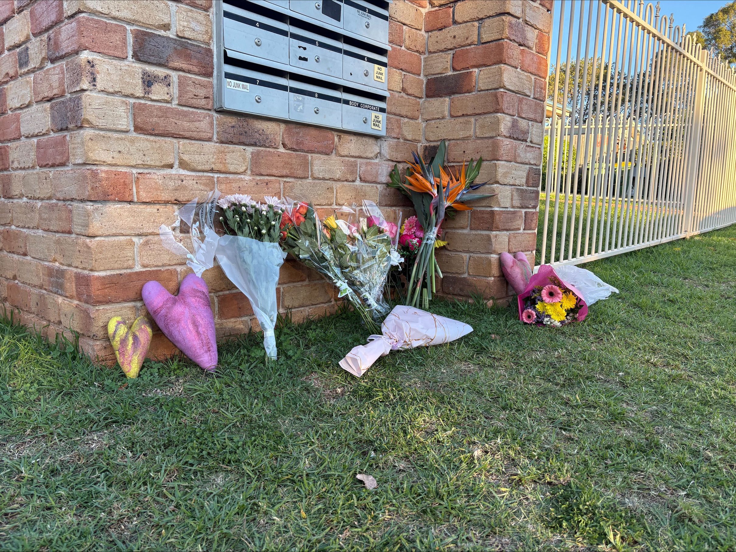 Floral tributes have been placed outside a red brick house.