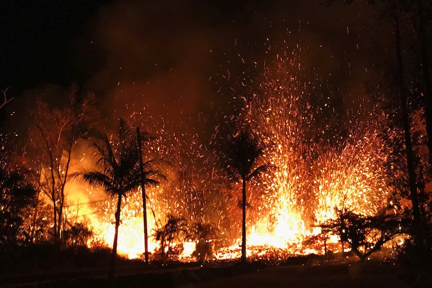 Lava spurts into the air at night