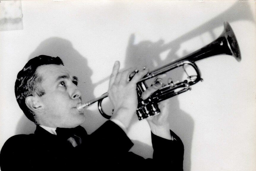 A man in a suit playing a trumpet