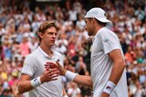 Kevin Anderson (L) and John Isner shake hands at the net after their Wimbledon semi-final.