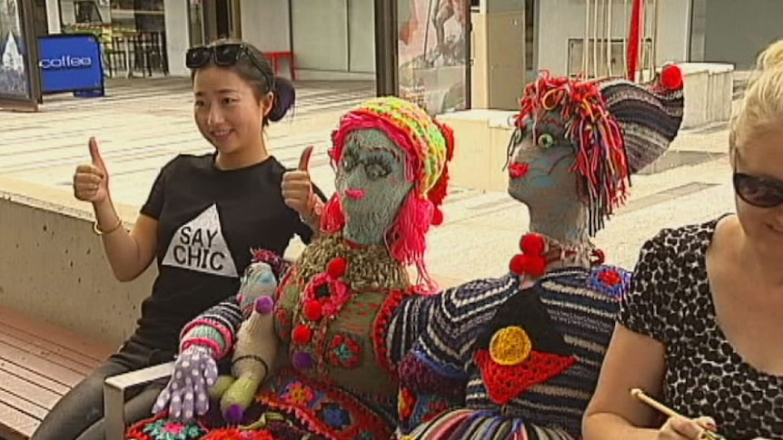 Knitted people figures with tourist in Townsville's CBD in December 2014