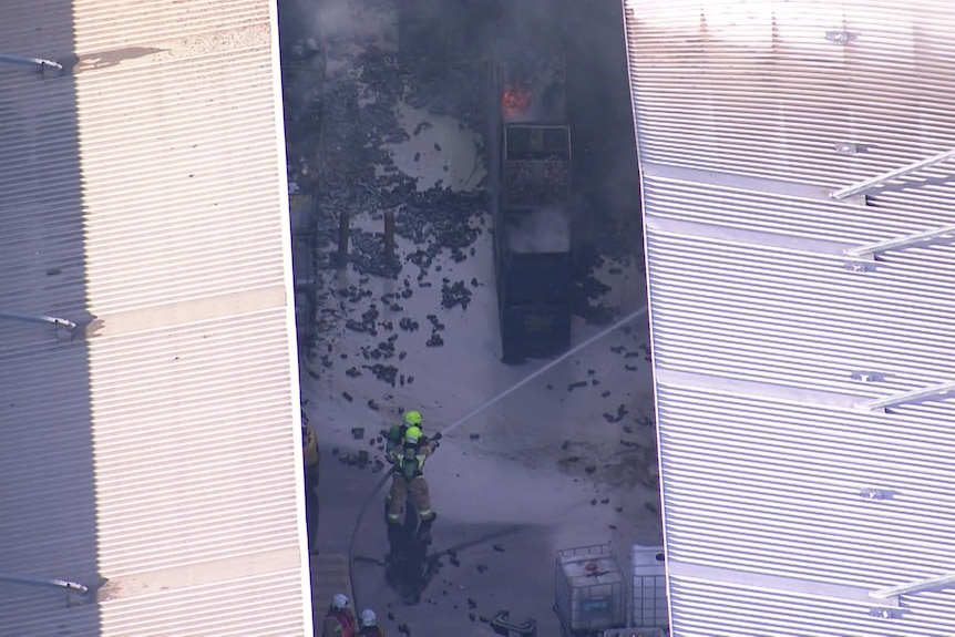 A man putting out a blaze at a factory