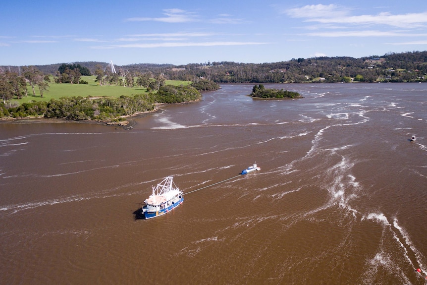 Aerial  of barge on Tamar River towing a turbine