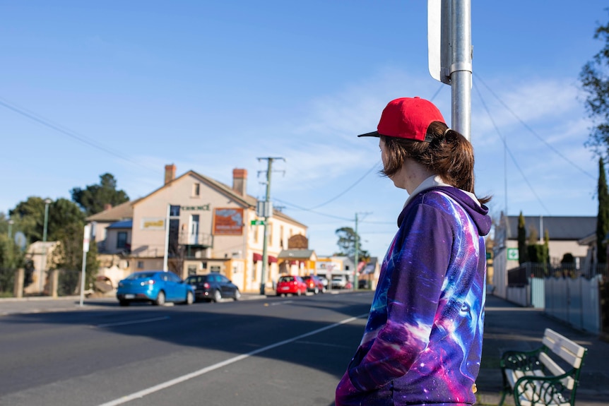 Jacob Foster waits for a bus at a bus stop in Latrobe. 