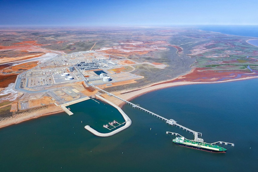 A wide shot of an LNG plant in the Australian desert coastline