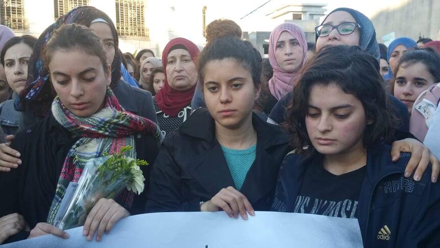 Noura Maasarwe (centre) and Ruba Maasarwe (right) at a vigil for their sister in Israel