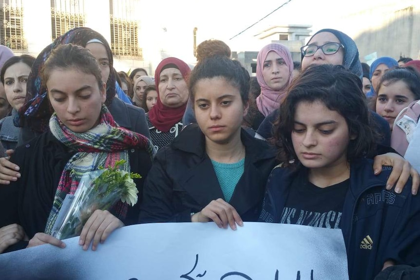 Noura Maasarwe (centre) and Ruba Maasarwe (right) at a vigil for their sister in Israel