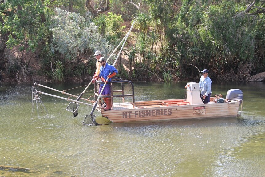 three men in a boat on the Katherine River