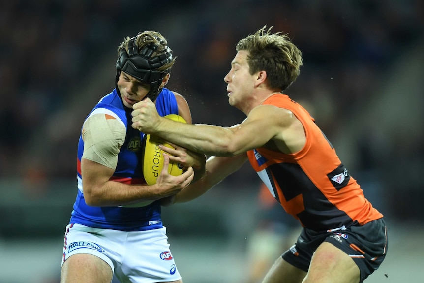 Toby Greene (R) makes contact with the head of Caleb Daniel during the third quarter.