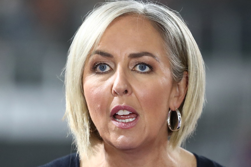 A headshot of Liz Ellis commentating on TV during a Super Netball game.
