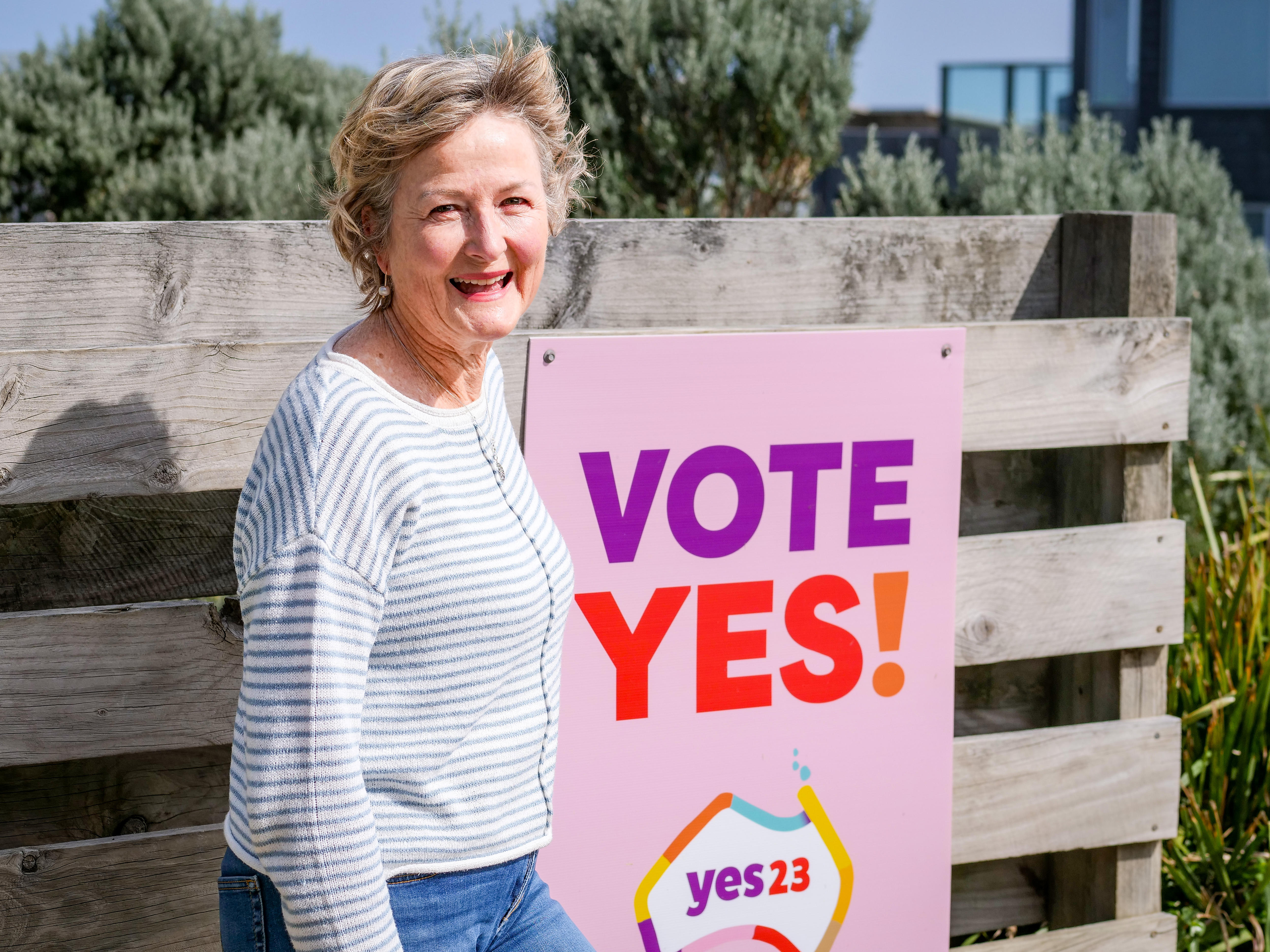 Monica Sammon stands near her yes sign