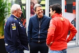 Helmut Marko, Peter Hardenacke and Carlos Sainz speaking in the F1 paddock at Japan