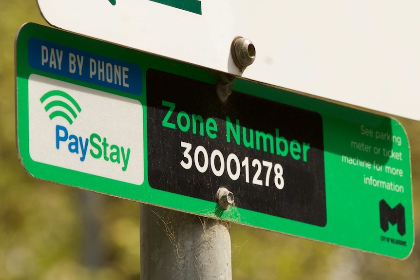 A parking sign encourages people to pay or parking using the PayStay app on their phone.