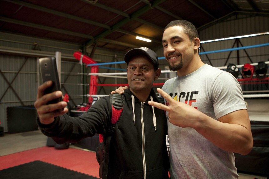 Whittaker and a man taking a selfie.