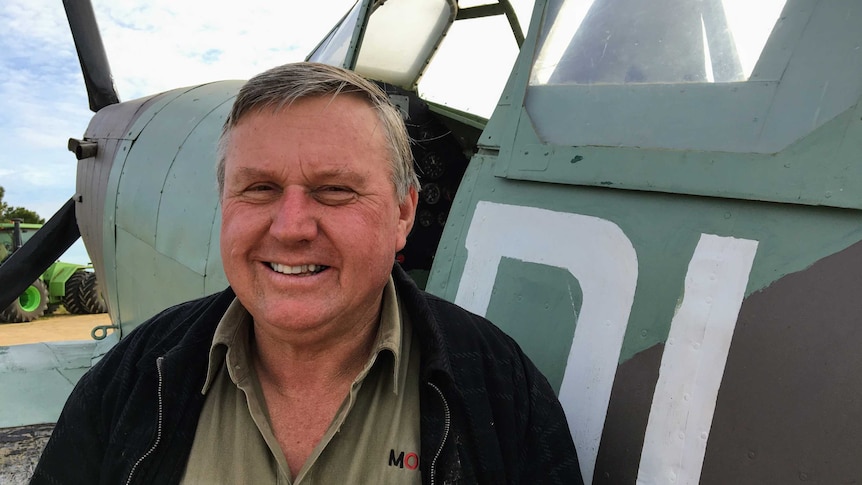 Mallee farmer Jeff Morgan stands in front of replica Spitfire