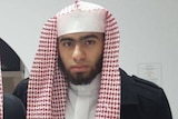 Isaak el Matari wearing arab headwear