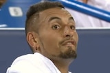 Eyebrows raised with his mouth ready to make an "F" sound, Nick Kyrgios looks to his players' box while sitting between games.