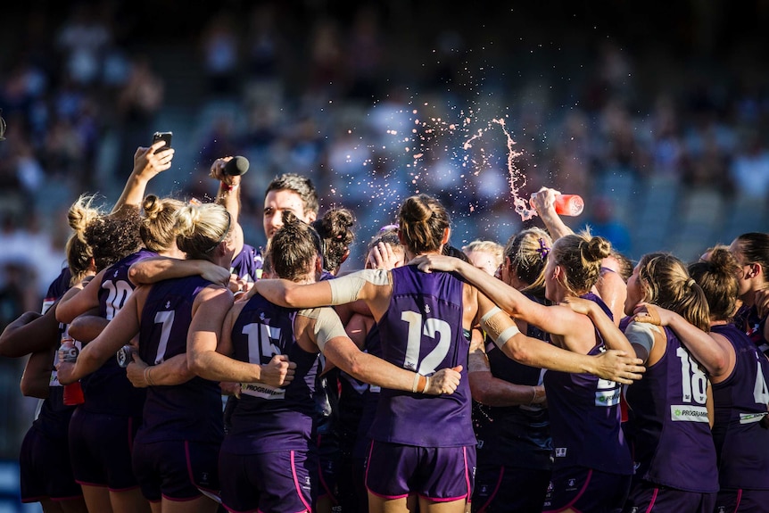 Fremantle players celebrate their win over Collingwood in round two of AFLW on February 10, 2018.